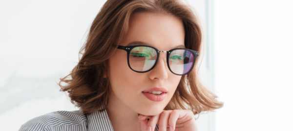 woman wearing blue light glasses