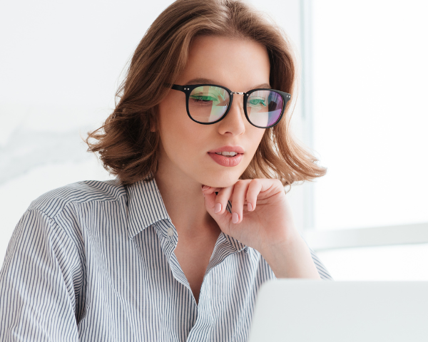 woman wearing blue light glasses