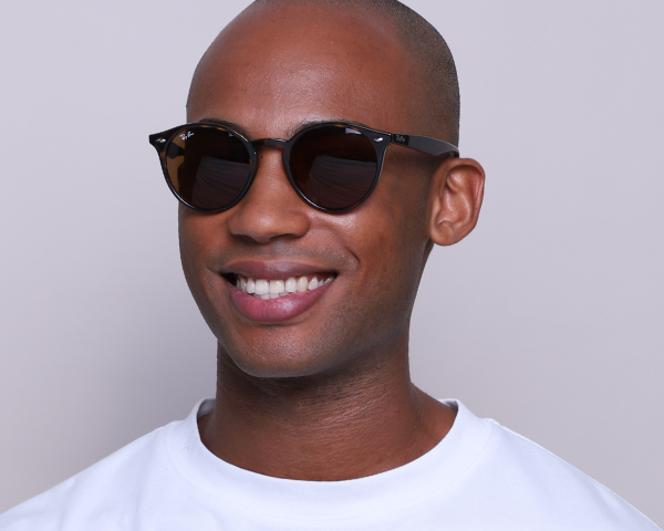 Male model wearing round sunglasses
