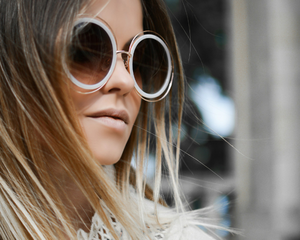 woman wearing oversized round sunglasses
