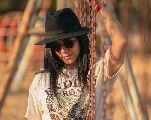 woman wearing a black wide brimmed hat and sunglasses
