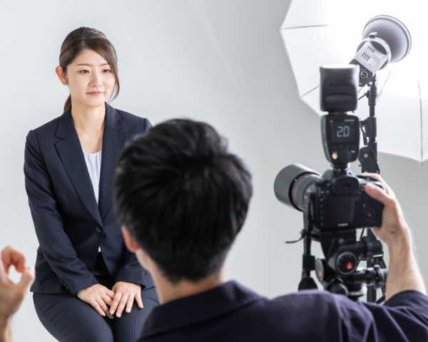 woman taking a passport photo