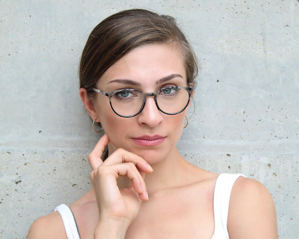 woman wearing black and white oval eyeglasses