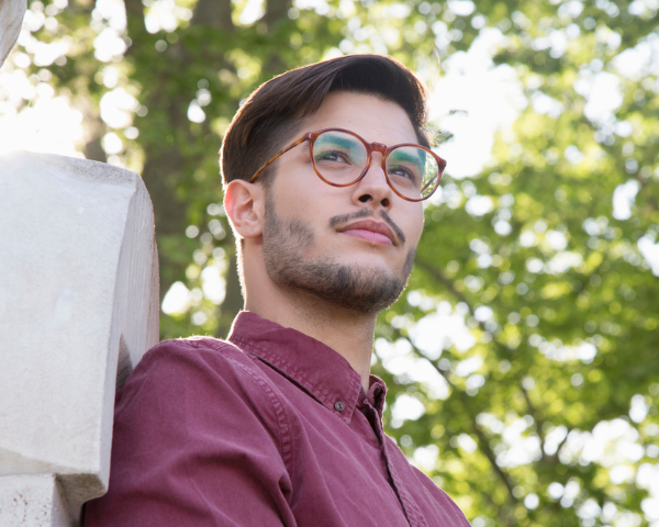 man wearing oval orange patterned eyeglasses