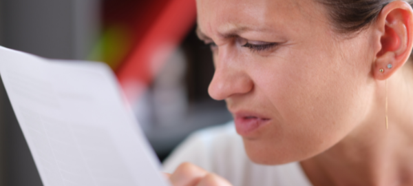 woman with worsening eyesight struggling to read