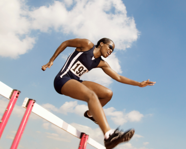 olympic athlete doing hurdles and wearing sports sunglasses