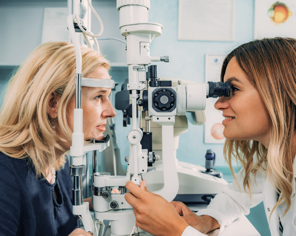 elderly woman taking a professional eye exam