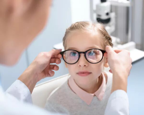 young girl being fitted for prescription glasses
