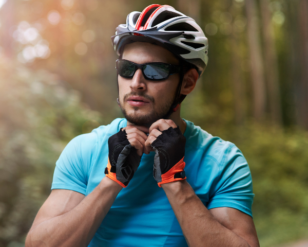 male cyclist wearing black wraparound polarised sunglasses with mirrored lenses