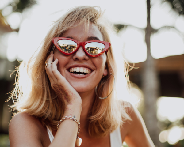 woman wearing red sunglasses with mirrored lenses