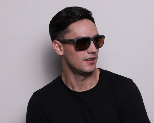 Man wearing brown shade Oakley sunglasses