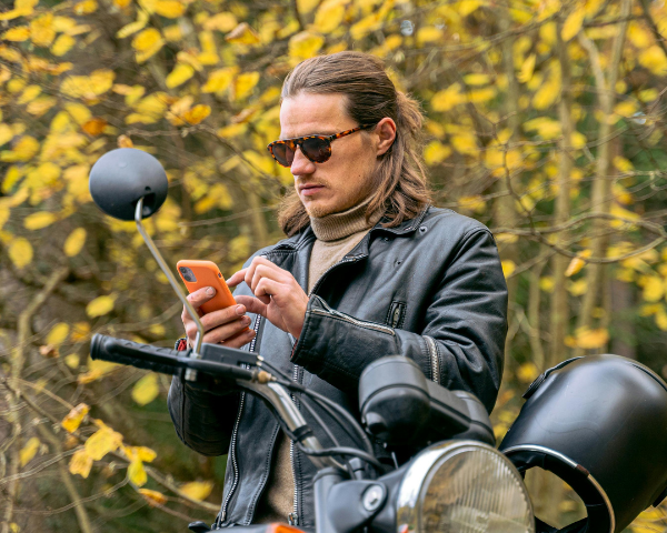 Man wearing sunglasses using his phone