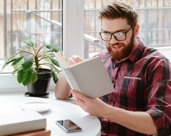 Man reading a book wearing glasses