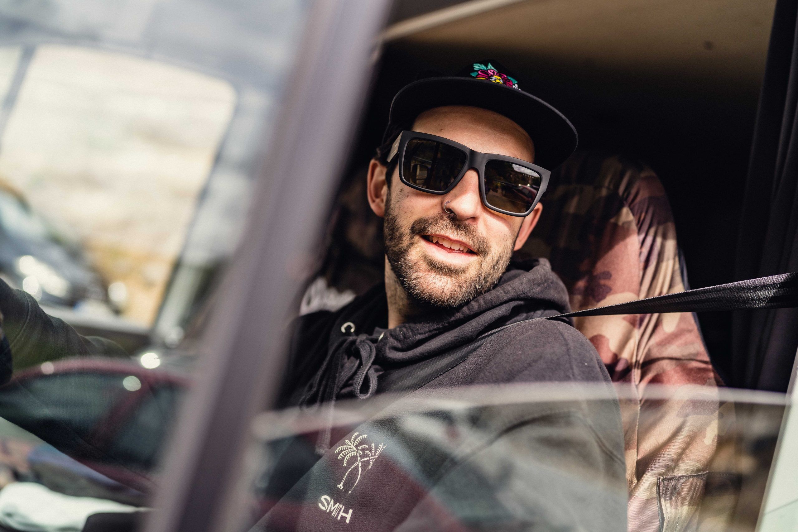 man in a car wearing smith sunglasses