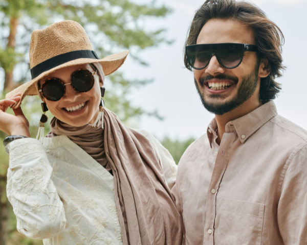 A man and a woman wearing desginer sunglasses