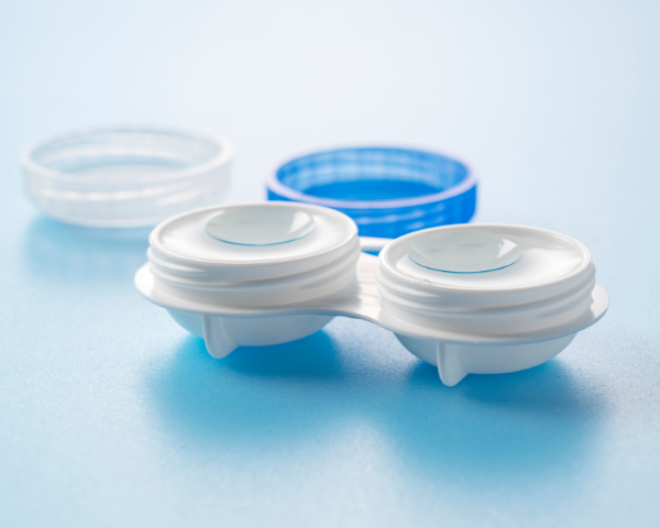Open contact lens case with contacts inside