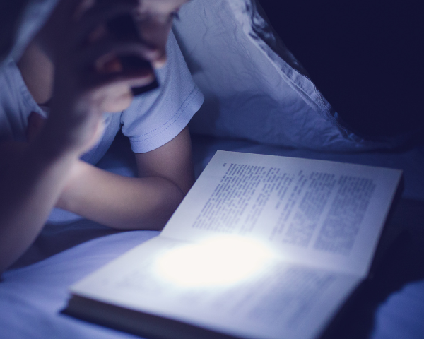 man reading in the dark