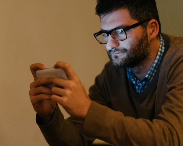 man with glasses looking at the screen