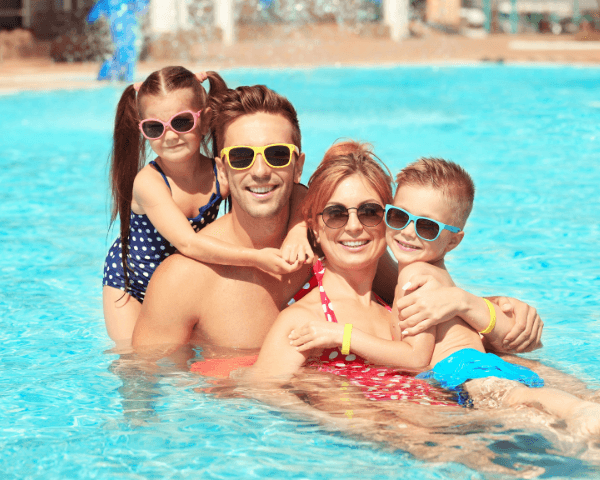 a family on a swimming pool with their sunglasses