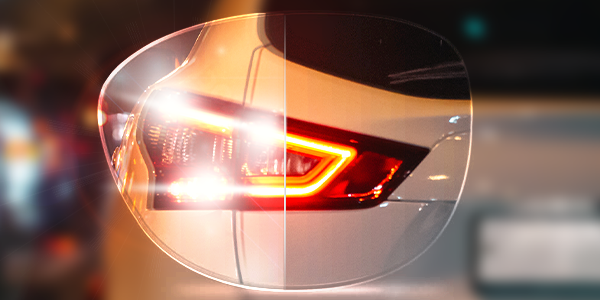 Lens in front of car light showing the difference between anti-glare effect and no anti-glare.
