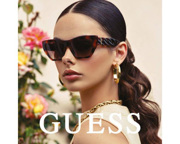 woman wearing Guess sunglasses