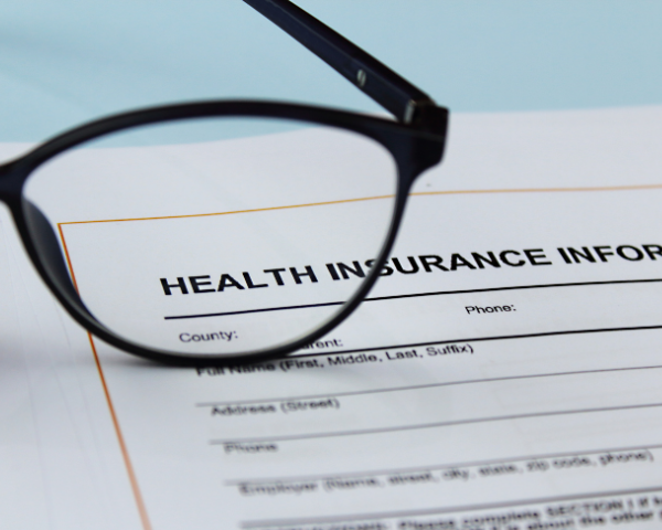 Glasses frames on top of health insurance document