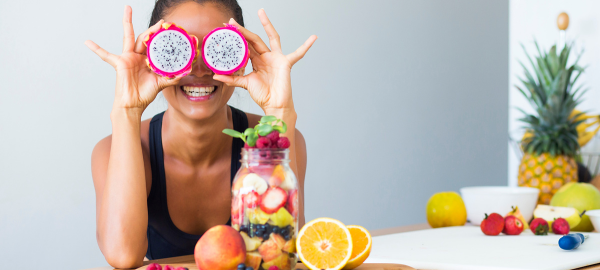 woman posing with fruit