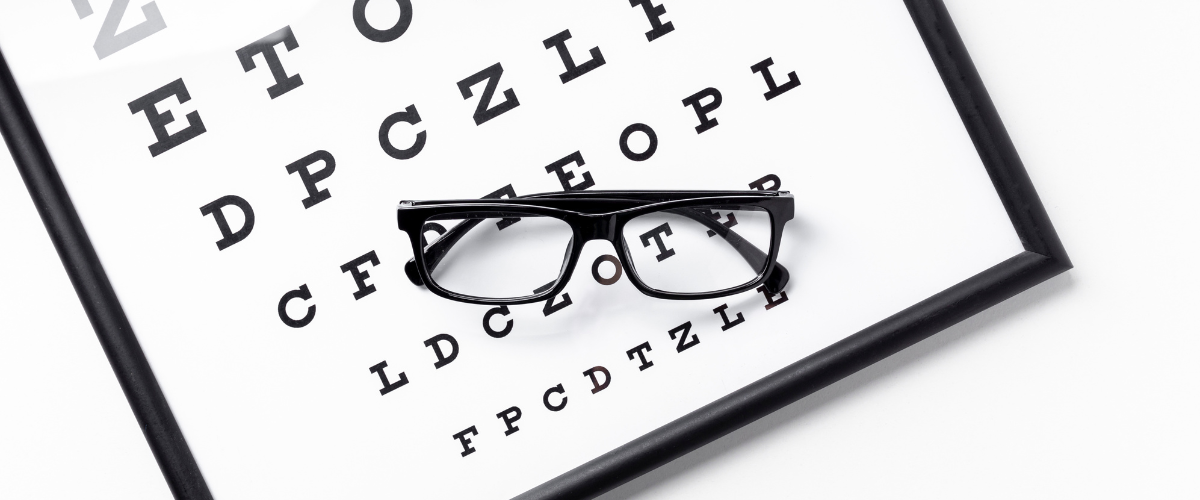 glasses resting on eye chart