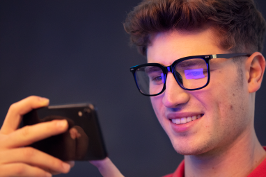 man wearing blue light glasses