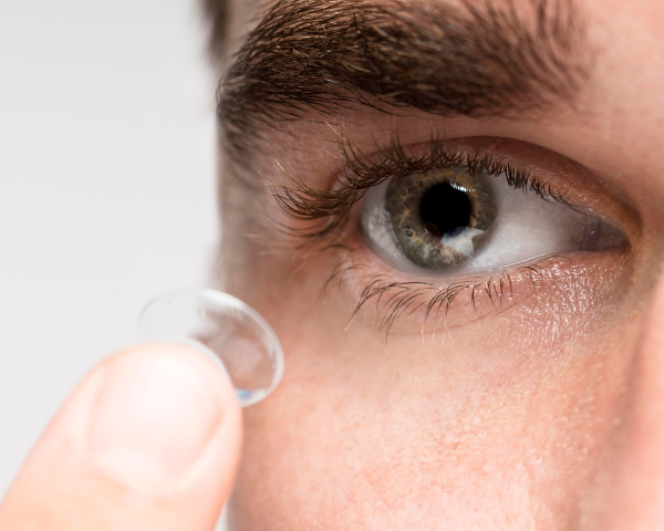 man putting in contact lens