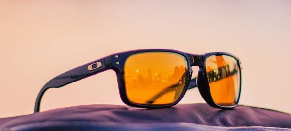 a pair of orange-tinted Oakley sunglasses