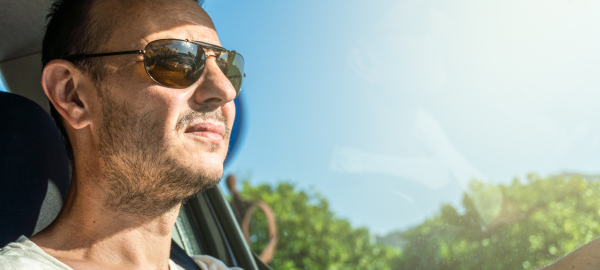 man wearing polarised lenses while driving during the day