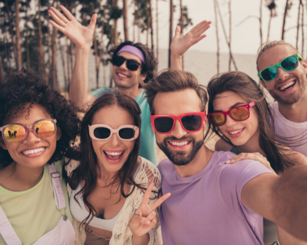 Group of friends wearing colorful glasses