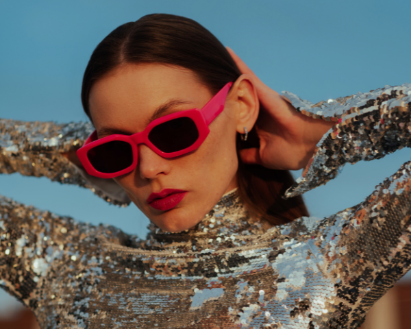 girl wearing bright pink rectangular sunglasses