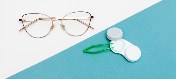 Pair of glasses on one side with a white background, a pair of contact lens case on the right side with a blue background