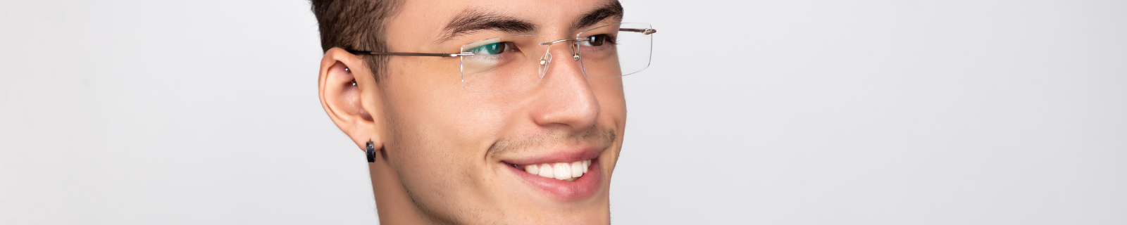 Youthful man wearing rimless glasses