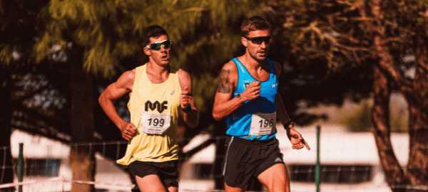 two males running in park wearing sunglasses