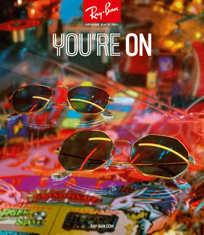 two gold frame ray ban sunglasses led on bright arcade table