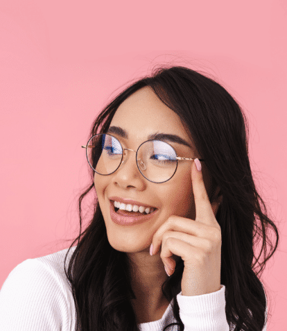 young asian woman smiling wearing blue light glasses looking left