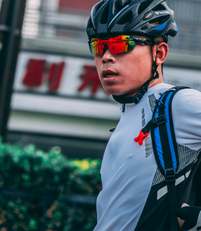 Man wearing cycling gear with tinted glasses