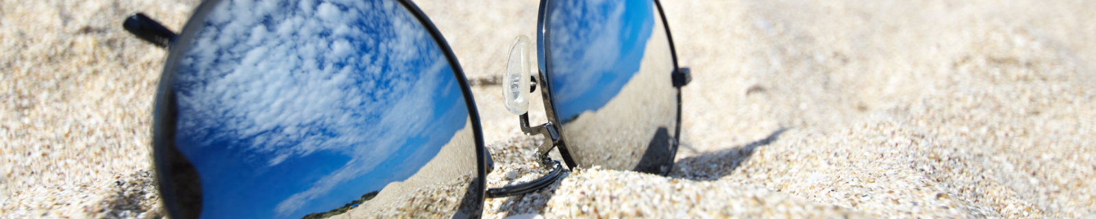 Mirrored sunglasses on beach