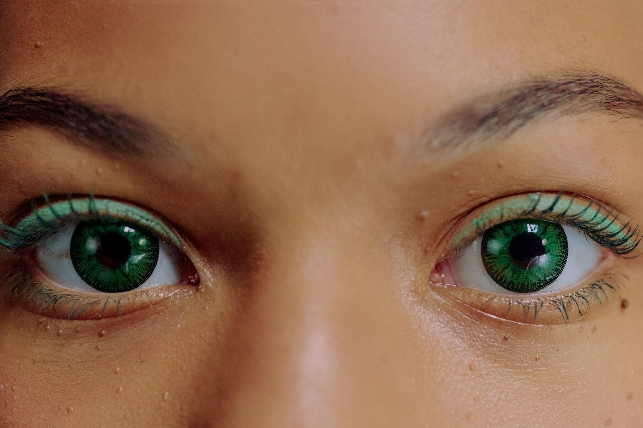 Girl wearing green coloured contact lenses
