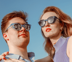 man and woman in the sun wearing sunglasses