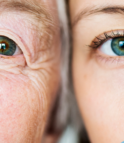 an old person and a young person look into the camera