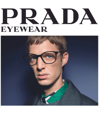 prada male model wearing black thick frame glasses and green printed shirt