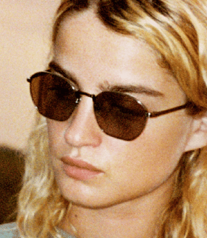 blonde model wearing persol sunglasses