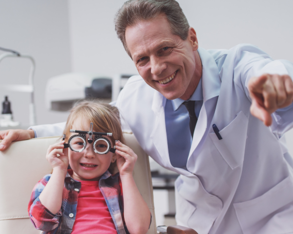 Child with an optician smiling at the camera