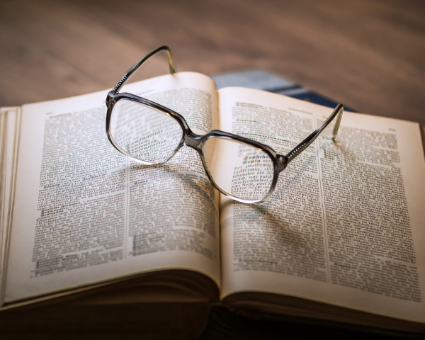 Book with glasses on top