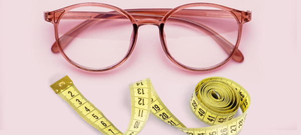 Pair of glasses and measuring tape