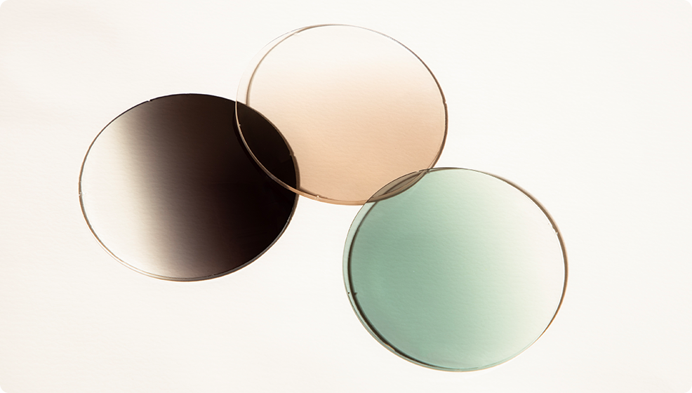 three inted lens options in gray, brown and green